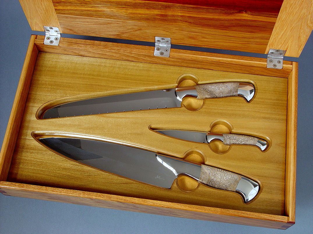 "Chef's Set" obverse side view in CPM154CM stainless steel blades, 304 stainless steel bolsters, Petrified Palm Wood gemstone handles, case of Pecan, Arririba, Padauk, Bloodwood, Bocote, Poplar, stainless steel