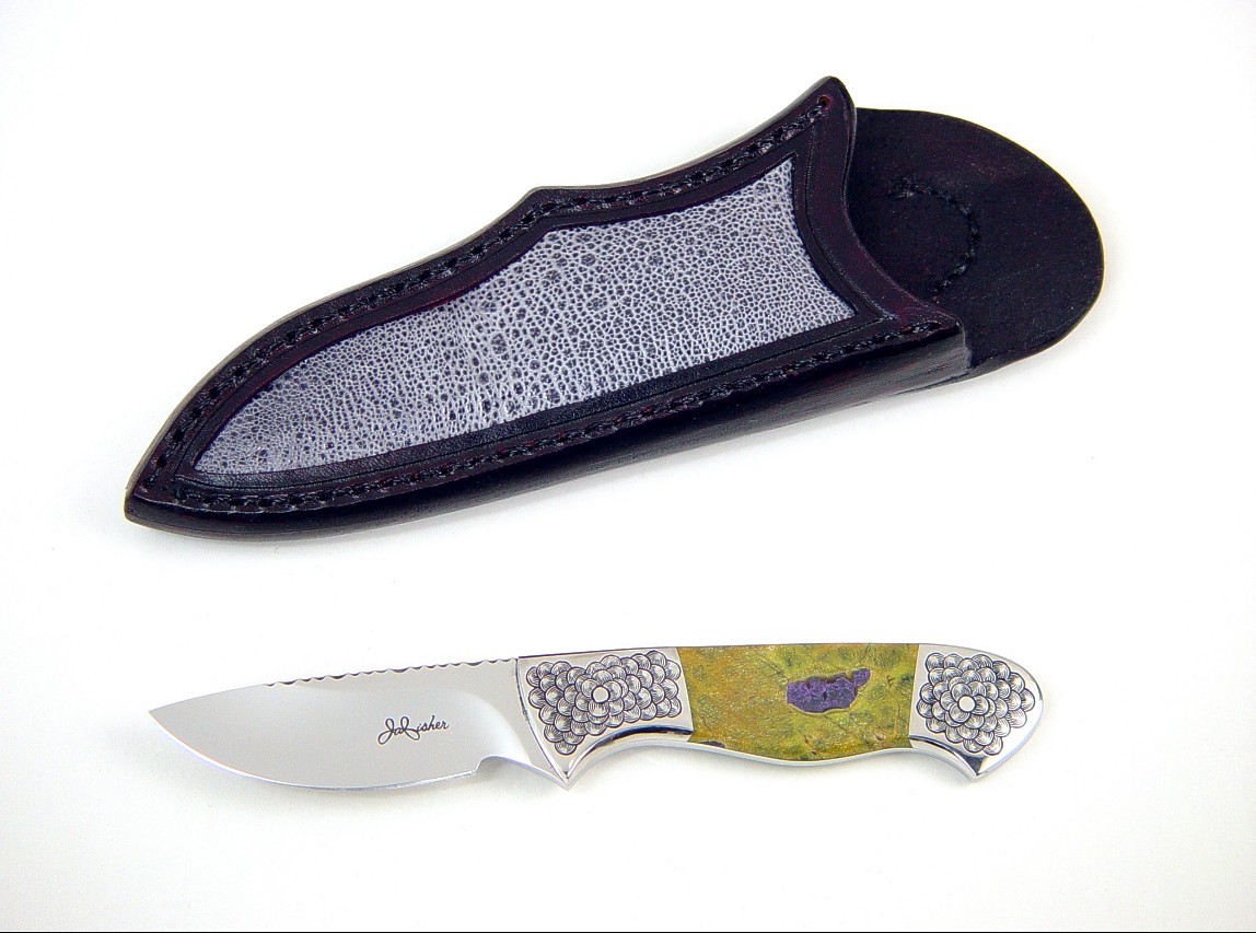 "Pyxis" obverse side view in 440c high chromium stainless steel blade, hand-engraved 304 stainless steel bolsters, Atlantisite gemstone handle, frog skin inlaid in hand-carved leather sheath