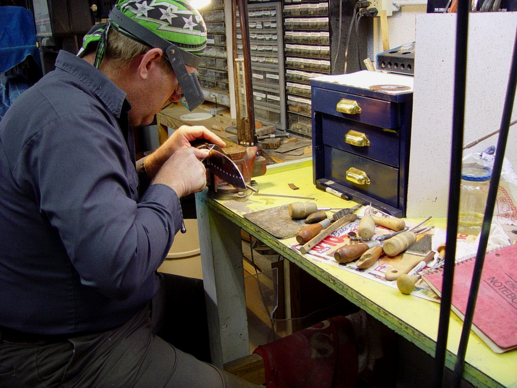 Fileworking in the studio. This may take hours on each knife. Try to do this left-handed with a torn shoulder rotator cuff!