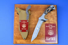 "Uvhash" Custom Commemorative Pararescue Knife, obverse side view, in 440C high chromium stainless steel blade, 304 stainless steel bolsters, coyote/black G10 handle, hybrid tension lock kydex, anodized aluminum sheath, plaque in ash, engraved maroon lacquered brass